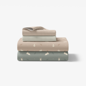 Soft, bohemian baby nursery bedding. Muted pastel crib sheets with bunnies. Spring and Easter seasonal decor.